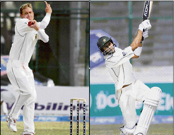 South Africas Paul Harris (L) took five wickets in Pakistans first innings and Shoaib Malik (R) hits a six to complete his 1,000 runs in Tests during the third days play of the first Test match in Karachi on Wednesday. 