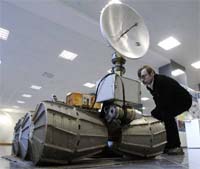 A man looks at a model of a Marsokhod Mars rover in the exhibition hall of the Institute of Space Research in Moscow on Thursday.