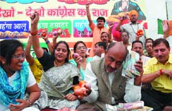 Activists of BJP stage a dharna at Town Hall, Chandni Chowk, to protest against the Delhi government for the rise in prices of onion, tomato and potato in the Capital on Friday