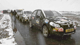 Motor car rallyists on their way back to Keylong from Patseo, Indian Army's Travellers checkpost, as a heavy snowfall on the higher reaches of Lahaul & Spiti put the brakes on the rally