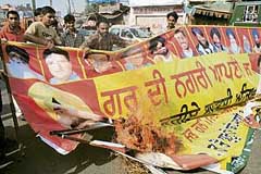Relatives of Praveen Kapoor burn posters of BJP leaders in Amritsar on Friday.