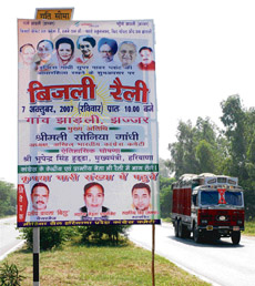 Scores of posters like these near Madhuban on the GT Road have been fixed on highway signboards displaying the accident helpline and speed limits