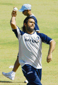 Mohinder Singh Dhoni throws a ball during the net sessions at the Sector 16 cricket stadium in Chandigarh on Sunday.
