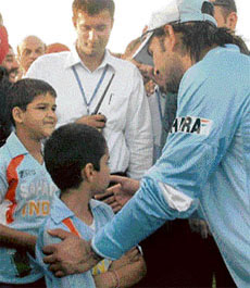 Indian skipper M.S. Dhoni with the son of Priyanka and Robert Wadhera.