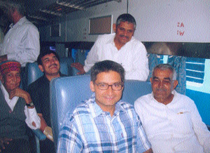 Deepender Singh Hooda, MP from Rohtak (sitting left in front row), on board the Rohtak-New Delhi express at New Delhi Railway Station on Monday. UPA chairperson Sonia Ganshi flagged off the train at Rewari on Sunday.