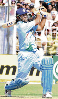 Mahendra Singh Dhoni hits a last-ball six off the bowling of Australias Nathan Bracken during the fourth one-dayer at the Sector 16 Cricket Stadium in Chandigarh on Monday