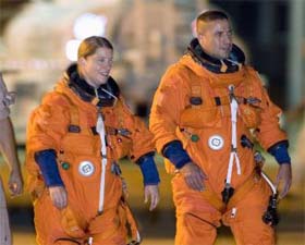 Space shuttle Discovery Commander Pam Melroy (left) and Pilot George Zamka walks to the space shuttle training aircraft at the Kennedy Space Center in Cape Canaveral, Florida