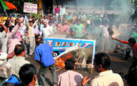 BJP activists burn the effigy of a Blueline bus during a protest in the Capital on Tuesday