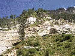 Khanol, once lush green, now destroyed by the road.