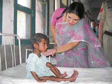 Deputy commissioner Deepti Umashankar with the malnourished boy, Ashwani, in the paediatric ward of the General Hospital in Hisar on Wednesday.