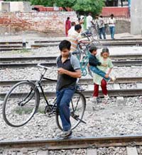 People cross the railway lines near Karnal station unmindful of the danger to their lives