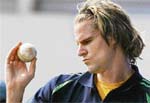 Australian fast bowler Nathan Bracken checks out a ball during a training session in Vadodara