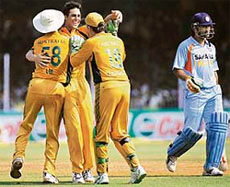 Australias Mitchell Johnson (2nd L) celebrates with team-mates Brett Lee (L) and Adam Gilchrist on dismissing Mahendra Singh Dhoni in the fifth one-dayer at Vadodara on Thursday.