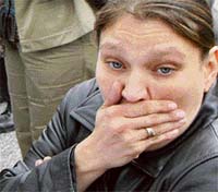 The mother of a SuccessTech Academy student reacts as she hears news of the shooting in the school in Cleveland, Ohio, on Wednesday. A 14-year-old student shot and wounded two adults and two students at the high school near downtown Cleveland, and then killed himself, the authorities said on Wednesday. 