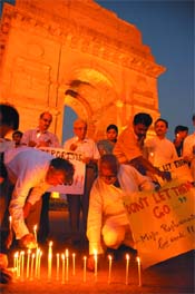 Family members and relatives of Major Dinesh Raghuraman, who recently laid his life in Kashmir pay a candle-light tribute to soldiers who died fighting terrorism, at India Gate In the Capital on Friday