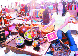 A stall-owner displays hand-made ethnic goods during an exhibition by JCI in Jalandhar on Friday