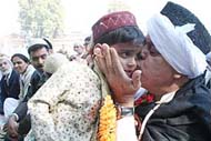 Former Chief Minister Farooq Abdullah kisses a child as Muslims offer Id prayers at Hazratbal in Srinagar on Sunday.