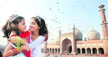 Children greet each other after prayer at Jama Masjid on the occasion of Id in Delhi