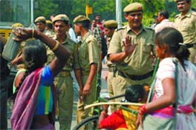 Policemen restrain disabled persons as their demonstration turned violent in the Capital on Monday.