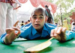 Rajat, a 12-year-old physically challenged boy from Gangar village, waits for his check-up at a medical camp for children with special needs in Karnal on Monday.