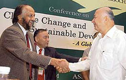 Power minister Sushilkumar Shinde (right) greets R.K. Pachauri, chairman, Intergovernmental Panel on Climate Change, at a seminar organised by the Associated Chambers of Commerce and Industry in New Delhi on Monday.
