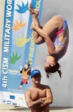 A diver practices at the pool as her coach looks on during 4th Military World Games at the Gachibowli indoor stadium in Hyderabad on Monday.