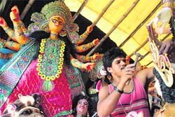 An artist gives finishing touches to idols of Goddess Durga in Siliguri, ahead of the five-day Durga Puja festival that begins on Wednesday.