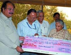 Power secretary hands over dividend cheque by Pragati Power Corporation Ltd. to Delhi Chief Minister Sheila Dikshit. Power minister A.K. Walia is also seen. 