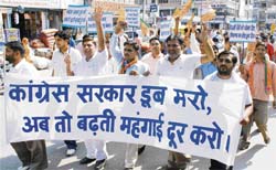 Activists of the youth wing of the BJP hold a protest in Karnal on Wednesday to highlight the power crisis and rising prices in the state. 