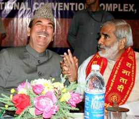 Chief Minister Ghulam Nabi Azad talks with union rural development minister Dr Raghuvansh Prasad Singh at the Sher-e- Kashmir International Convention Complex in Srinagar on Wednesday