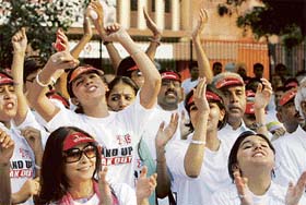 Volunteers take part in an event to promote awareness about the United Nations Millennium Campaign (UNMC) in New Delhi