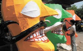 An artisan gives final touches to the effigies of Ravan, Meghnad and Kumbhkaran in the Capital