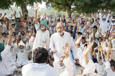 Residents of Malayi village in Mewat district raise their hands to endorse the decision to boycott antisocial elements