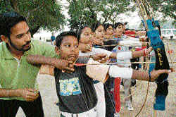 Budding archers get lessons from archery coach Gurpal (left) at Lake Sports Complex, Chandigarh, on Friday