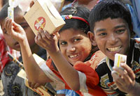 Children engaged in ragpicking display the free items given to them by the district administration at Bal Bhawan in Panipat on Friday.