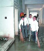 Lawyers pick up brooms to clean the complex.