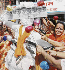 Members of a women’s organisation protest against Tamil Nadu Chief Minister M. Karunanidhi before burning his effigy at Sector 40, Chandigarh, on Monday.