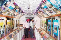 People watch the displays inside the Azadi Express, the exhibition train flagged off from Delhi to commemorate the 150th anniversary of the First War of Independence and 60 years of freedom, in Amritsar