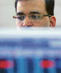 A stock trader watches his monitor during intra-day trading at a brokerage house in Mumbai on Tuesday.