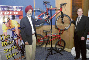 Managing director of FireFox Bikes Shiv Inder Singh (L) and international territory manager Peter St. Onge pose with the newly unveiled range of FireFox bikes in New Delhi on Tuesday.