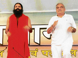 Haryana Chief Minister Bhupinder Singh Hooda along with Swami Ram Dev at a yoga camp in Sonepat on Wednesday.