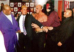 Wrestlers try to control Nikita, who grew violent due to postponement of wrestling championship, while Yokozuna looks on in Ludhiana on Thursday.