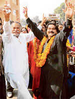 Pakistani folk singer Arif Lohar and Sufi singer Puran Chand Wadali dance after the arrival of a Pakistani delegation at Attari
