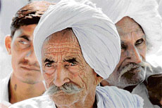Farmers from Haryana wait for Chief Minister Bhupinder Singh Hooda at his residence in Chandigarh on Friday.
