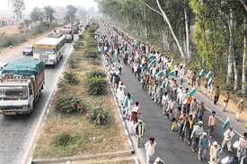 As part of their countrywide padyatra, landless tribesmen march on a road linking Agra and New Delhi in Palwal.