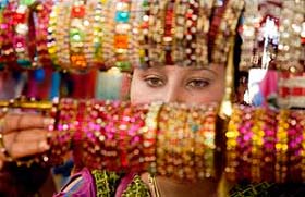 A woman selects bangles for Karva Chauth in Jammu