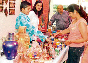 Visitors look at beautiful candles during the Karva Chauth mela at the Laxmi Ladies Club on Saturday, in Ludhiana.