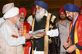 Chief Minister Parkash Singh Badal gives Lifetime Achievement Award to Dr Man Singh Nirankari at the 47th annual conference of the National Academy of Medical Sciences at Guru Nanak Dev University in Amritsar