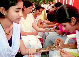 Girl students of GMSSS-32, Chandigarh, apply mehndi during Saawariya Karva Chauth Fair held on school premises