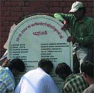 Traders of the Sarojani Nagar Market install a stone tablet in the memory of blast vicitims, in the Capital on Sunday.